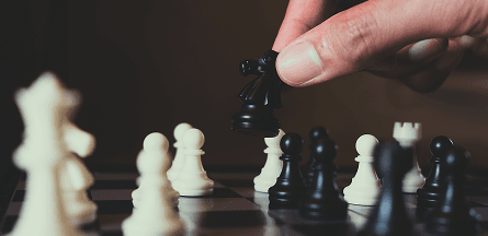 Chess board with person moving a piece