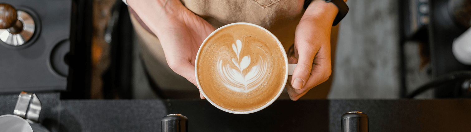 Latte in barista hands
