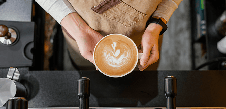 Person holding a fancy latte
